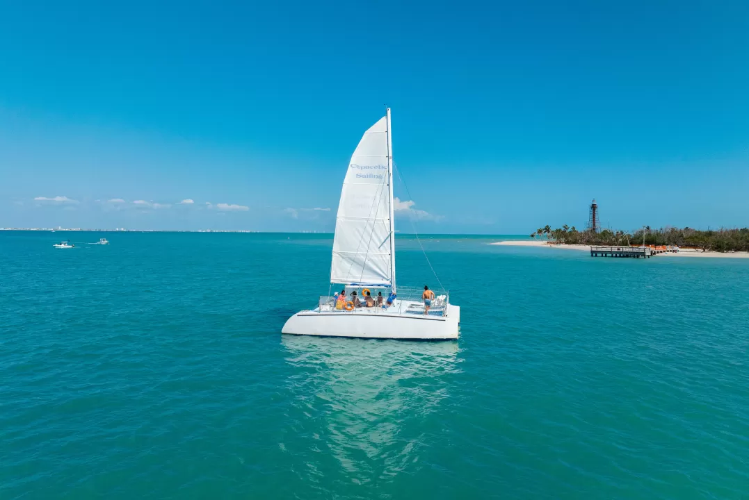 A small sailboat in the middle of a large body of water